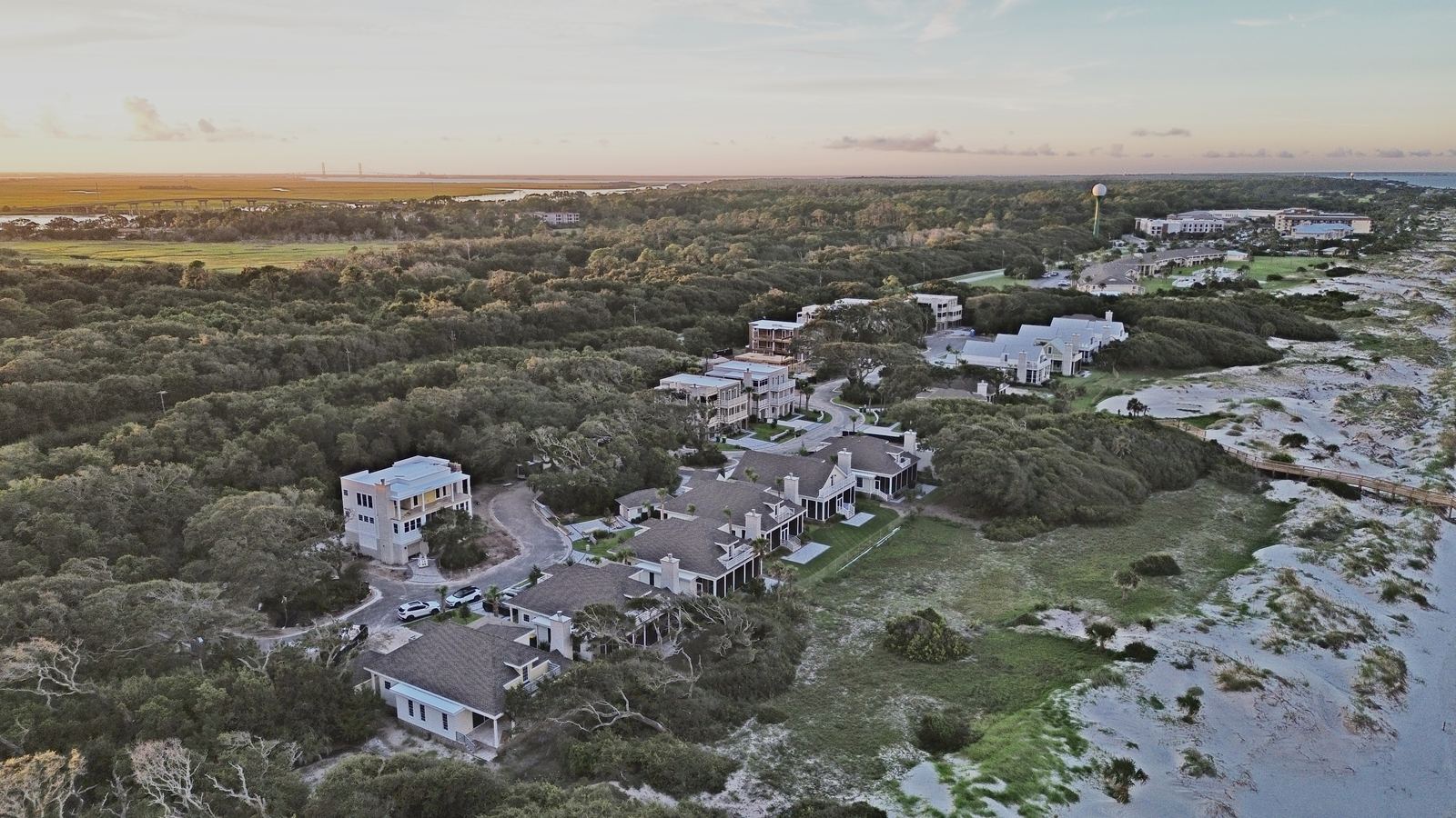Aerial view of the Seaside Retreat development on Jekyll Island, Georgia, showing homes under construction surrounded by maritime forest near the beach
